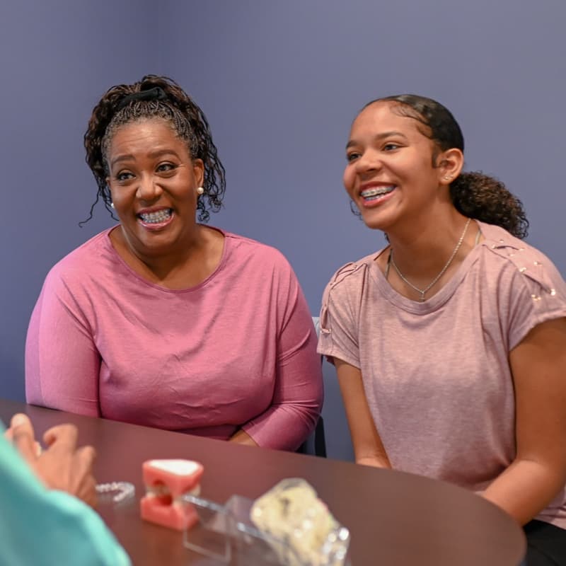 family smiling during orthodontic consultation